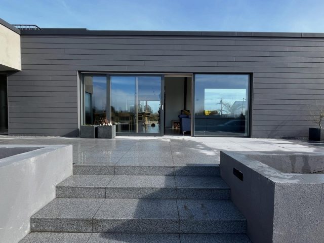 Outdoor Space is Loading 

We’ve just finished paving our outdoor spaces, adding 70+ sqm of new outdoor living to the home. Both spaces are designed as an integral part of the house — making the most of orientation, shelter and connection to the rooms inside.

One is a morning and afternoon space, linked to the kitchen and children’s rooms. The other comes into its own in the afternoon and evening, connected to the dining area and entrance. Having a variety of spaces means you can follow the sun, escape the wind, and find the right spot no matter the time of day or year — extending outdoor living well beyond the narrow window of an Irish summer.

Designed outdoor spaces matter. They connect us to the seasons, give the house room to breathe, and frame a view from inside. They allow the freedom to move barefoot from inside to out — something kids do effortlessly, naturally pulling their play outdoors.

Outdoor spaces shouldn’t be left to the end of a project. They should be integral to the design from the start — complementing the internal layout, positioned for sunshine and shelter, and connected to the rooms you use every day.

The details: Flamed surface granite paving, 900x600mm at 25mm depth, sourced from @mcmonagle_stone in Donegal. I stacked the joints in a grid rather than staggering them — less distracting, and it complements the modern architecture. 

A note on budget: costs go beyond the paving itself — factor in stone fill, cement, grout, manhole covers and sealer. Larger format pavers also mean more wastage. It’s a real investment, but the sooner you do it, the sooner you start enjoying it.

The paving was installed by @johnny_paving — a seriously professional contractor and a genuinely lovely person to work with. He takes real pride in his craft, treats his team well, and was brilliant at working through the finer details on site — My Dad said it best: “you can tell these guys are proud of their work.” 

Excited for spring, new planting and long evenings outside. #outdoorliving #patiodesign #outdoorspace #landscapedesign #irisharcitecture