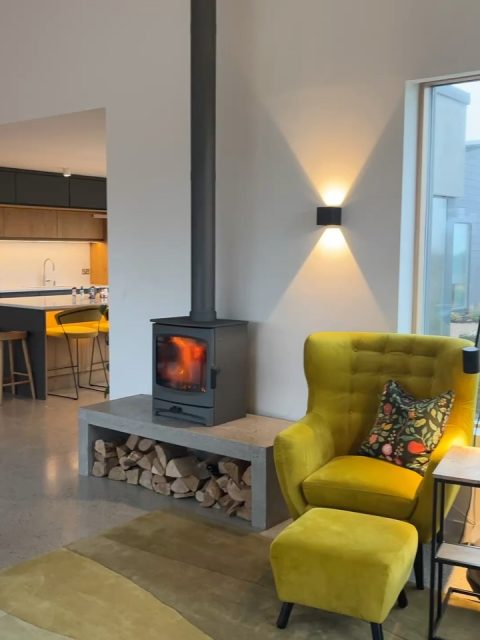 Tá an Tine Lasta 

Christmas arrived early this year in our home with the missing piece of the puzzle finally installed. It’s hard to beat the warmth and drama of a real fire. The ritual, company and focal point. It’s the anchor that was always intended and we already feel inseparable from it.  A fire is a living thing and it’s like welcoming a new member in our family.
 
Tá sé chomh te teolaí le nead smólaigh (It’s as warm and cosy as a thrush’s nest)
 
Christmas will be quiet and comfortable this year, enjoying time at home with friends, family and our community. The kids will miss their Daideo, their first Christmas without him, but they know he’s looking after them from the stars with their Mamó. We will miss his gentle soul and company at our table this year. He loved the ritual of putting down the fire (cur síos an tine) and we will think of him as we gather around our own fire this year. 
 
Wishing everyone a very Happy Christmas, especially my clients and collaborators, thank you for the business and I look forward to working with you in the year ahead and any new collaborators who would like to get in touch.
 
Some info about the stove:
The stove was purchased from @murphyheating Kinvara and Senje did a great job of the installation. It’s a Charnwood Aire 7 in Gunmetal grey, wood burning stove. The size of the room can easily accommodate the fire without been overpowering, the heating temperature rises to 22-23 degrees, so comfortable and cosy. The concrete bench was crafted by Cian to match our polished concrete floor. It’s designed to have a seat either side, so you can sit up to the heath of the fire, like the old traditional open hearths.

Níl aon tinteán mar do thinteán féin.
(There’s no place like home)
#irishhome #irisharchitecture #christmashome #woodburningstove #cosyhome