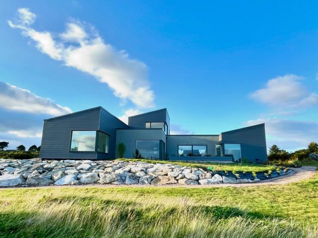 Belated one year Anniversary!
 
Living in our new home is a very different experience to building it, the activity of making and finishing a home is constantly in progress. I’ve fallen out of the practice of writing and sharing about the build as the challenges have evolved. The human messiness of life has taken over, from rearing small kids, work and keeping everyone fed, clean and happy.
 
We have lived through each of the four seasons in our home, appreciating the changing light, natures blooming and hibernation. Regardless of the weather outside, we have always been comfortable and safe, a far cry from our friends in Palestine, Lebanon and Ukraine, who we wish we could do more to help. There is feeling of guilt and gratitude that comes with enjoying our forever home. 
 
The ‘summer’ or should I say the time that passed between May and September has been focused on outside work, preparing the ground, planting and nurturing. The rain probably hasn’t been a bad thing for the new plants, they could establish their roots and produce some serious growth. The focus has definitely shifted from from construction dust to muck. 
 
It’s obviously still a work in progress, we haven’t paved the seating areas yet, but the planting has started to soften the edges, I look forward to been able to wander barefoot from inside to out, all in good time. We’ve enjoyed having a part lawn even if unfinished, so the kids could play football during the summer, the Euros, Olympics and the many Galway team finals provided plenty of inspiration.
 
During the bright months of May, June and July, we barely turned on an electric light enjoying the luminescence of the long evenings. The to do list has not shortened, we just keep adding more items to it and there is a ban on me saying ‘I have an idea’ until we make more progress.
 
The photos are certainly not instaperfect, but they are a work/life in progress, there definitely has been an evolution when you look at the bare area we started with, nature grows at its own pace and we need to be patient and receptive to its needs.  
If anyone has any questions, feel free to ask! #selfbuild #lifeafterthebuild #dreamhome #irishdesign